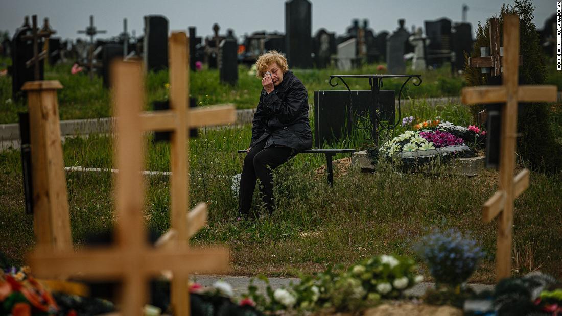 ハルキウの墓地にあるウクライナ軍兵士の墓の区画を訪れた女性/Dimitar Dilkoff/AFP/Getty Images