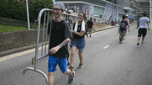 道路を封鎖するための柵を運ぶ学生