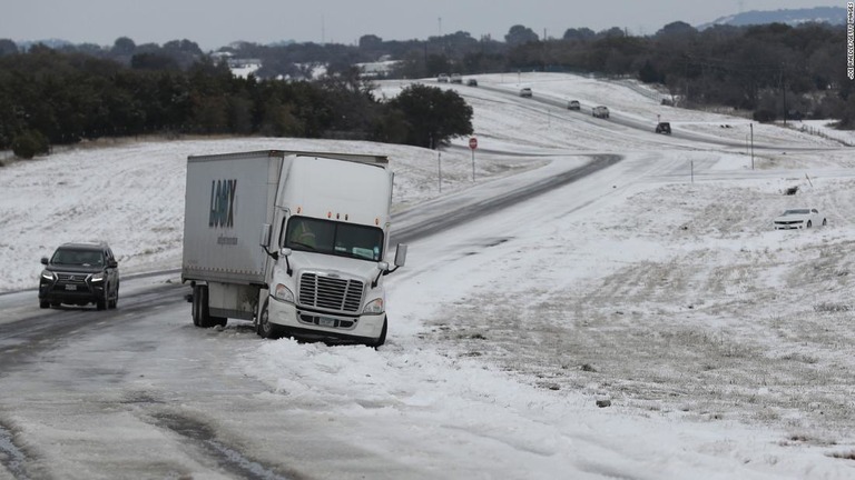 路面凍結と降雪により立往生している車両＝１８日、米テキサス州キリーン/Joe Raedle/Getty Images