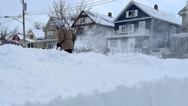 米ニューヨーク州バファローで自宅の前の雪かきをする男性/Bridget Haslinger/AP