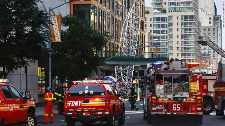 建設用クレーンを調査する消防士ら＝２６日、米ニューヨーク市マンハッタン/Kena Betancur/AFP/Getty Images