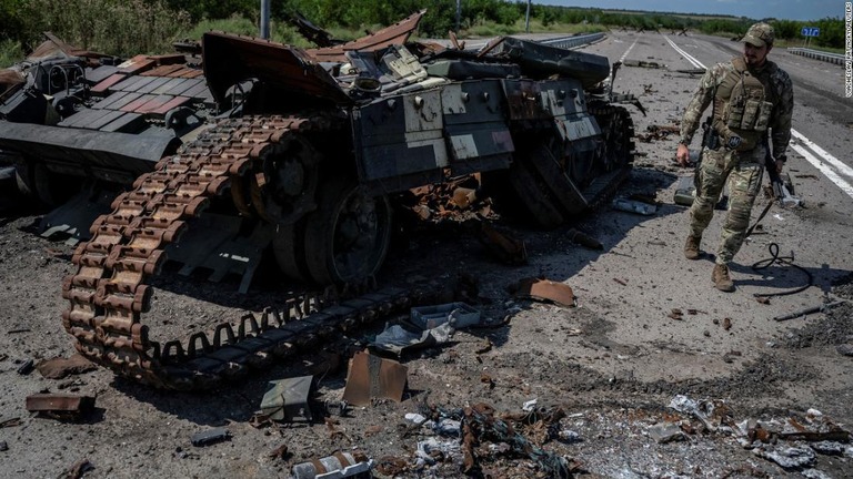 破壊されたウクライナ軍の戦車の近くを歩くウクライナ兵＝８月２５日、ウクライナ・ザポリージャ州/Viacheslav Ratynskyi/Reuters