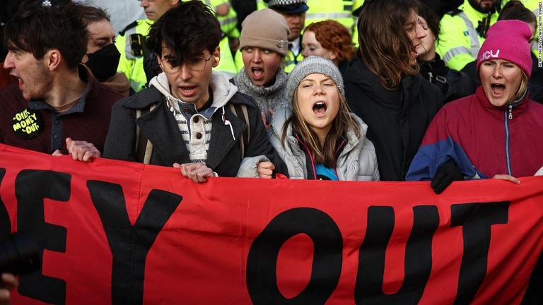 横断幕を持ってデモに加わるトゥンベリさん/Henry Nicholls/AFP/Getty Images