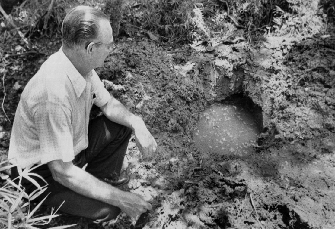 １１歳の少年が埋められた場所の近くに座る保安官＝ルイジアナ州/Bettmann Archive/Getty Images