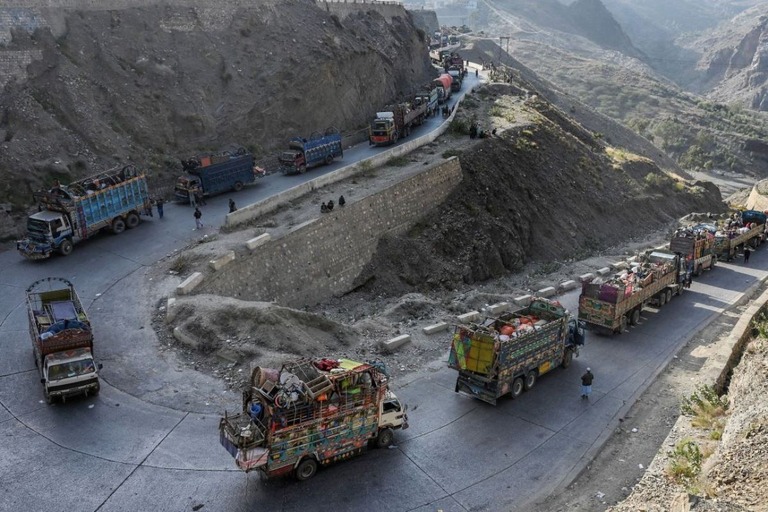 アフガンからの避難民と荷物を国境地帯へ運ぶトラック＝２０２３年１１月/Abdul Majeed/AFP/Getty Images