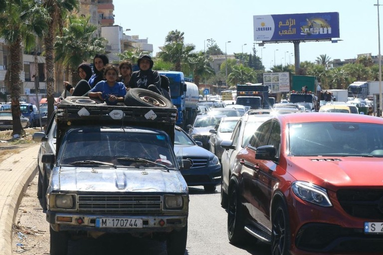 荷物をトラックに積み込んで避難するシリア人の一家＝２３日、レバノン・サイダ/Mahmoud Zayyat/AFP/Getty Images